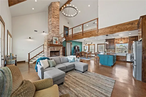 a living room with furniture kitchen view and a fireplace