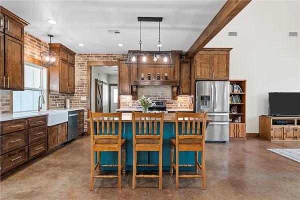 a large kitchen with a table and chairs