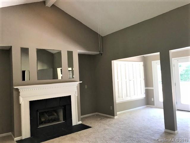 5512 Griffith Road Monroe, NC 28112 - Photo 13 of 36 a view of an empty room with a fireplace and a window