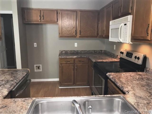 5512 Griffith Road Monroe, NC 28112 - Photo 21 of 36 a kitchen with a stove and a refrigerator