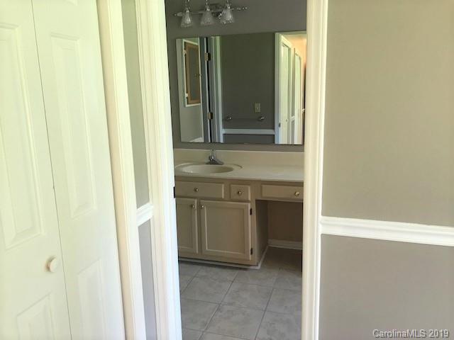 5512 Griffith Road Monroe, NC 28112 - Photo 23 of 36 a bathroom with a sink and a mirror