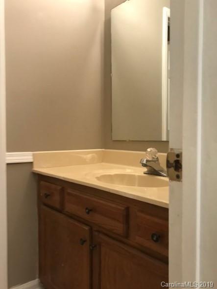 5512 Griffith Road Monroe, NC 28112 - Photo 31 of 36 a bathroom with a sink and a mirror