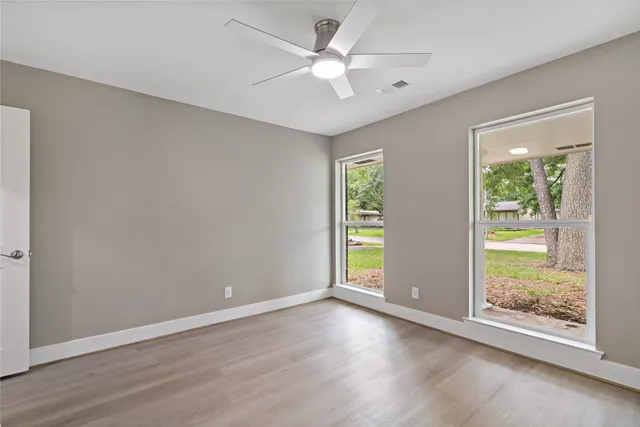 wooden floor in an empty room with a window