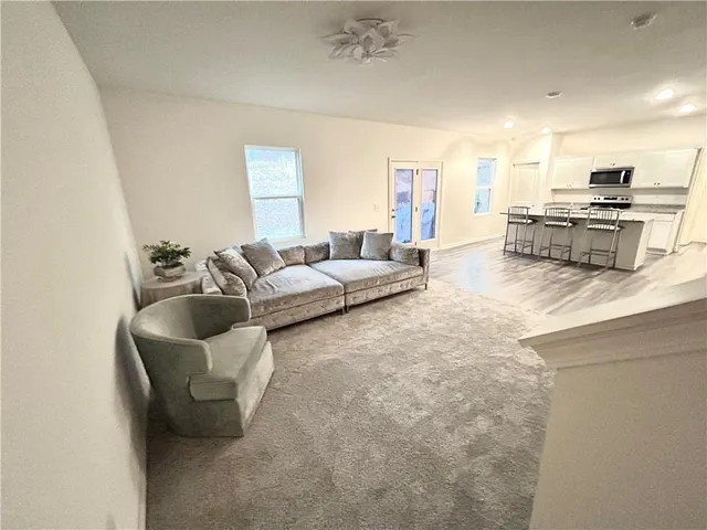 a living room with furniture and kitchen view