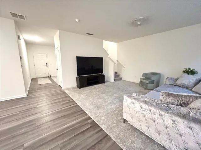 a bedroom with a bed and a television