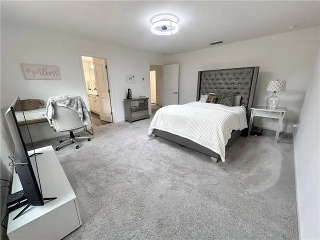 a bedroom with a bed a desk and chair
