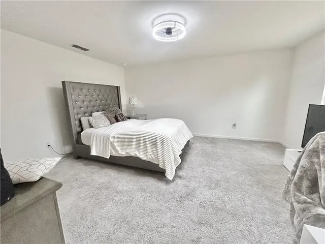 a bedroom with a bed and a couch