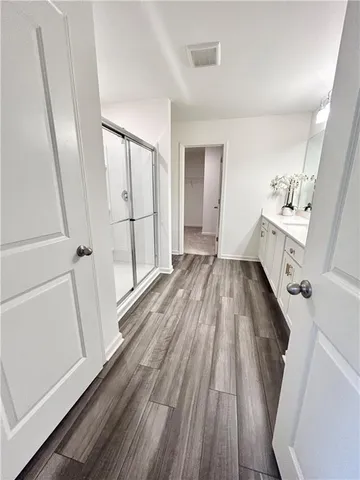 a view of a room with wooden floors and staircase