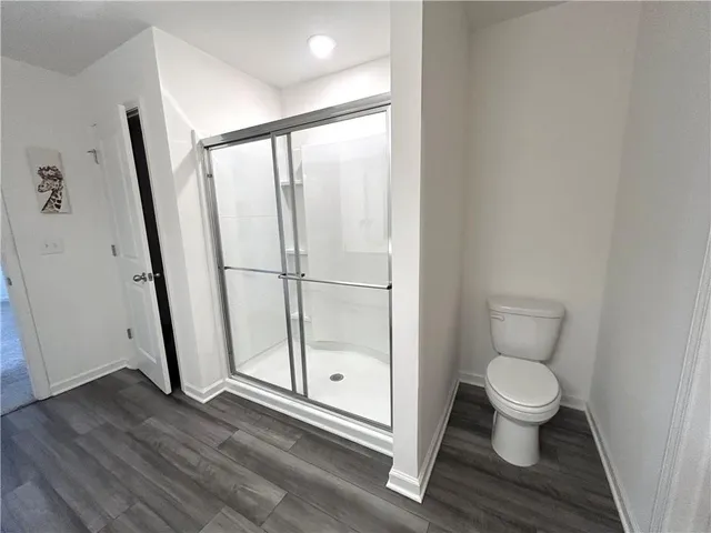a bathroom with a toilet and a shower