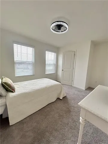 a bedroom with a bed and window