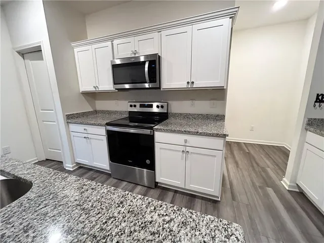 a kitchen with a sink stove and microwave