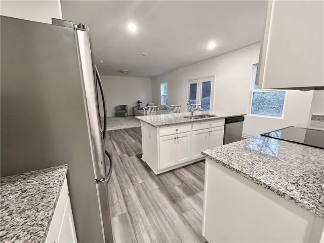 a kitchen with a sink stove and refrigerator