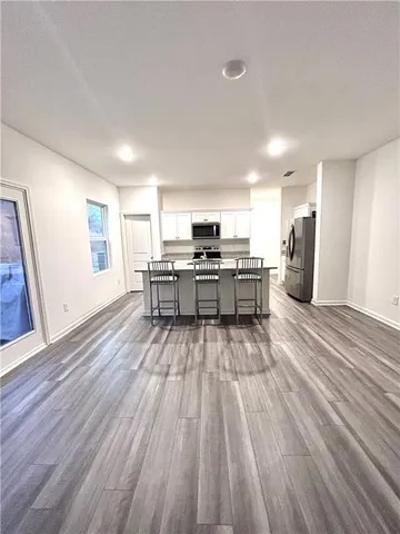 a view of kitchen with sink microwave and refrigerator