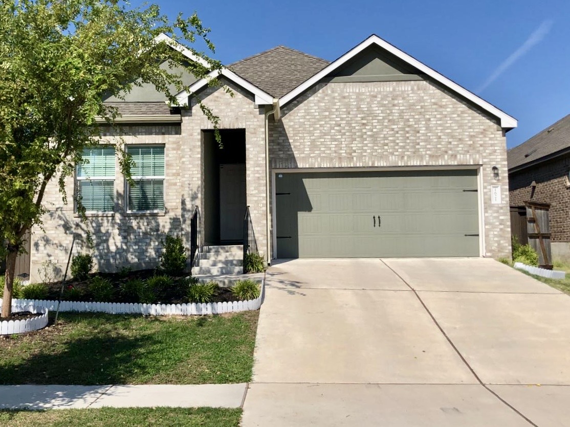 1621 Brueggerhoff Road Leander, TX 78641 - Photo 3 of 28 Single-story residence featuring light-colored brick facade and a multi-gabled roofline