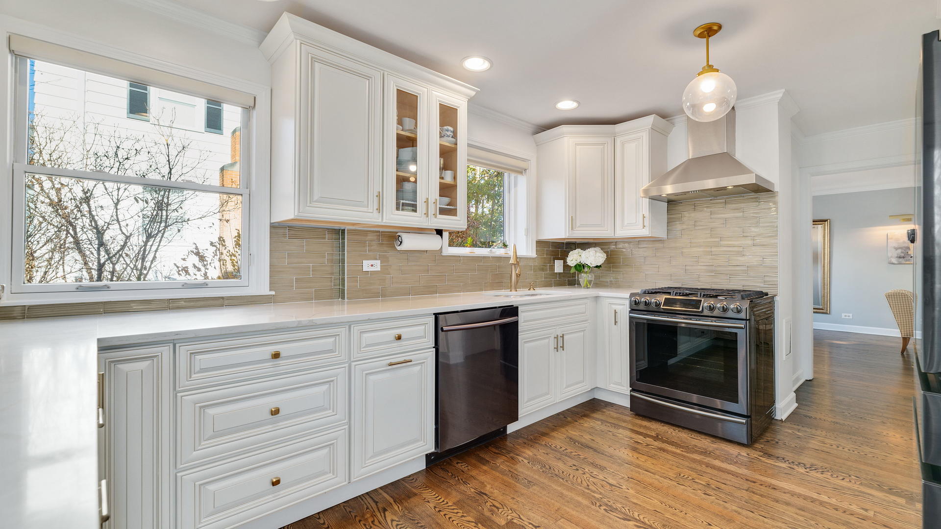 105 Ravine Road Hinsdale, IL 60521 - Photo 18 of 35 a kitchen with stainless steel appliances granite countertop a stove a sink and a granite counter tops with wooden floors