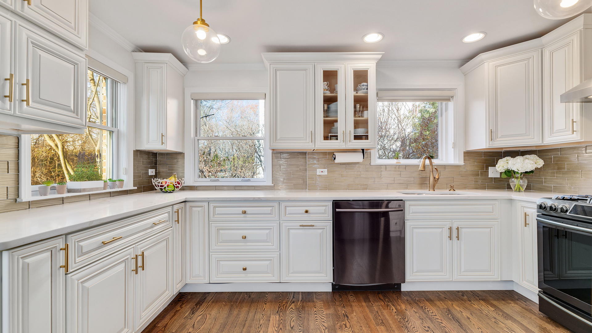 105 Ravine Road Hinsdale, IL 60521 - Photo 10 of 35 a kitchen with granite countertop white cabinets and stainless steel appliances