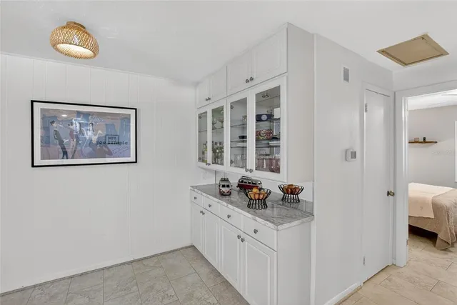 a bathroom with a granite countertop sink toilet and mirror