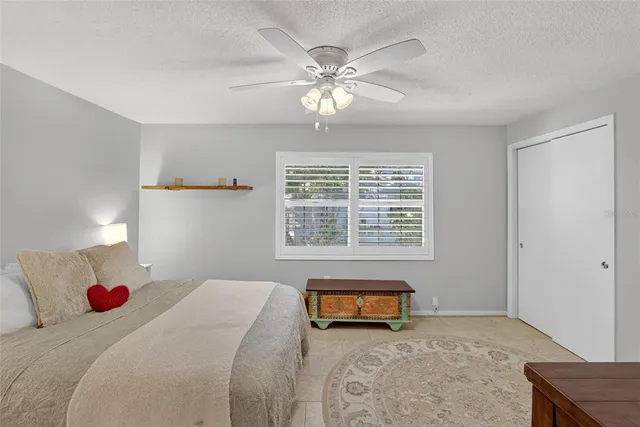a bedroom with a bed and ceiling fan