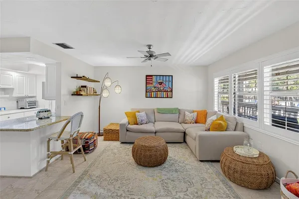 a living room with furniture flat screen tv and window