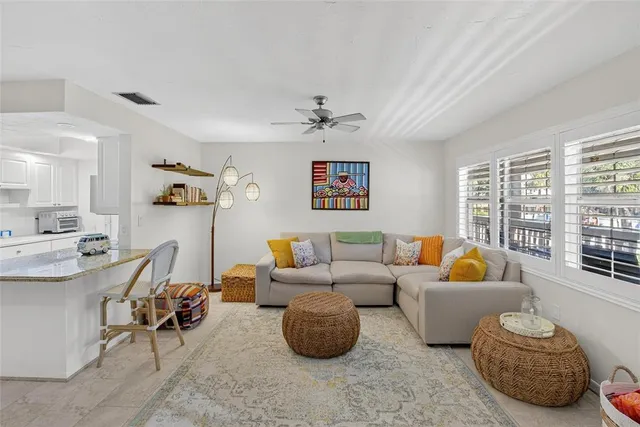 a living room with furniture flat screen tv and window