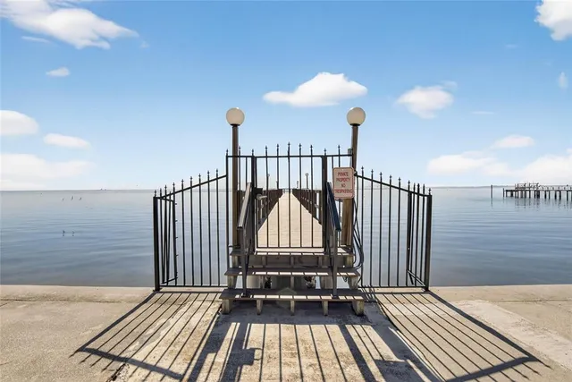 a view of a room with wooden floor and fence