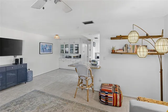 a kitchen with stainless steel appliances granite countertop a sink dishwasher and white cabinets with wooden floor