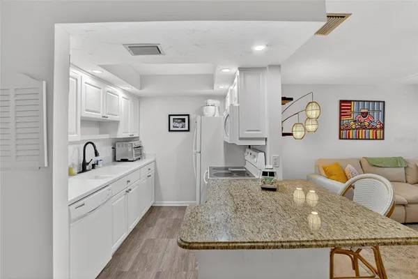 a kitchen with a sink stove and cabinets