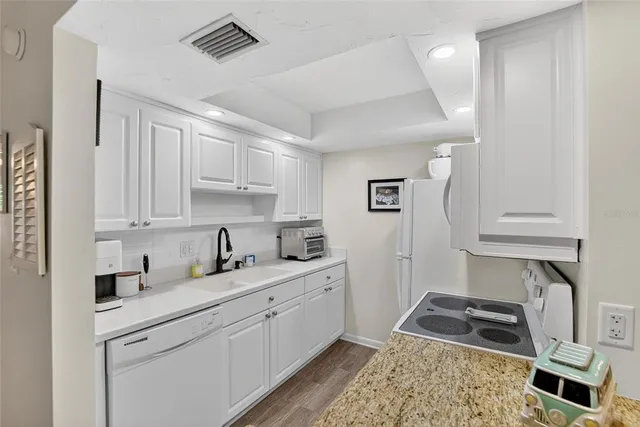 a kitchen with stainless steel appliances granite countertop a stove a refrigerator and a refrigerator