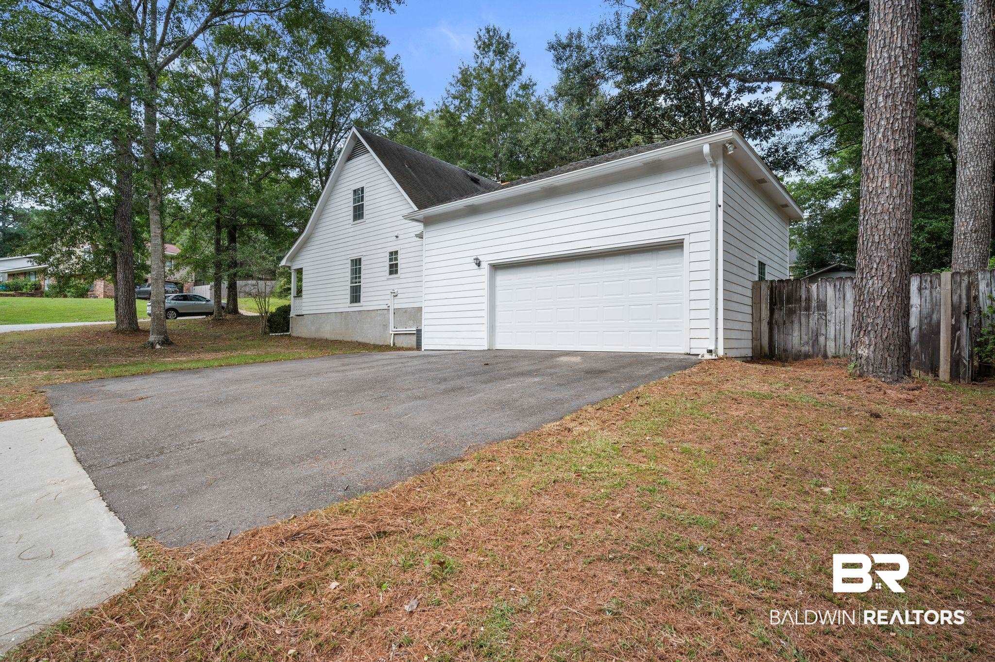 100 Montclair Loop Daphne, AL 36526 - Photo 5 of 39 View of property exterior with a yard and a garage