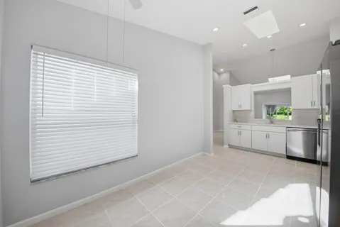 a kitchen with white cabinets and white appliances