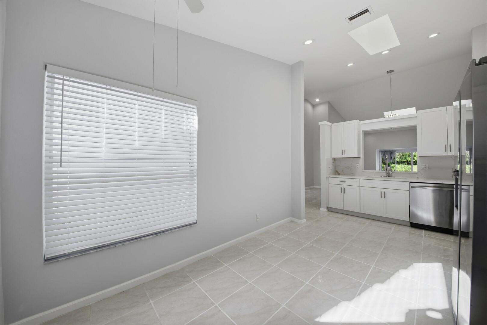 7617 Island Breeze Terrace Boynton Beach, FL 33437 - Photo 11 of 46 a kitchen with white cabinets and white appliances