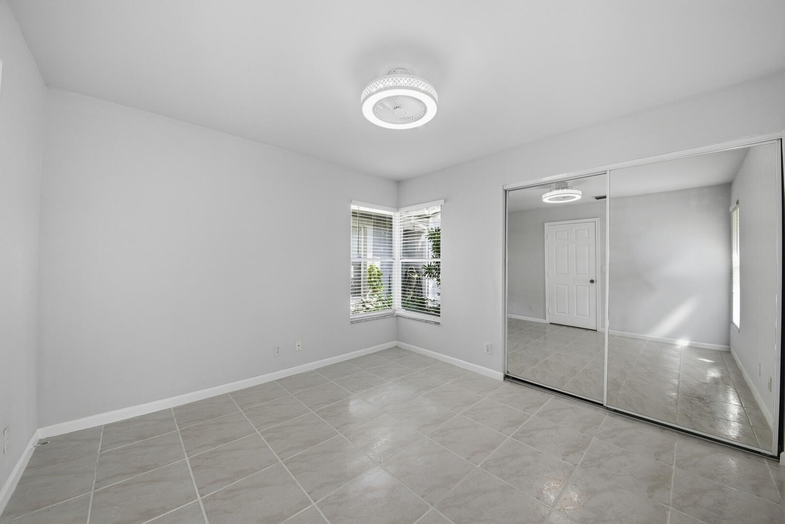 7617 Island Breeze Terrace Boynton Beach, FL 33437 - Photo 2 of 46 an empty room with windows and closet