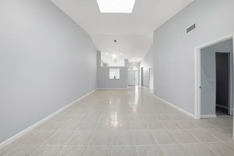 a view of a hallway with wooden shelves