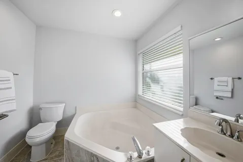 a bathroom with a double vanity sink mirror and