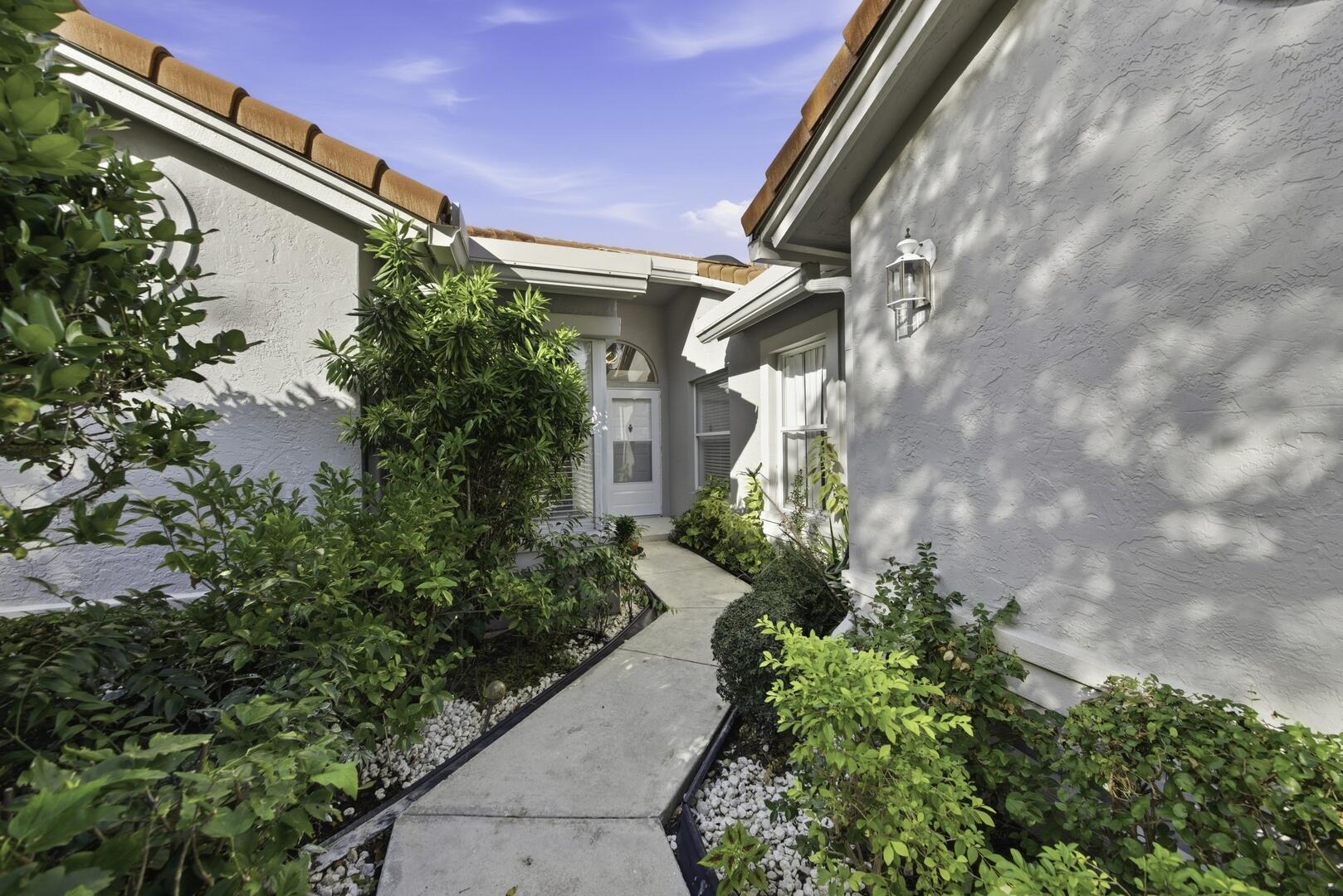 7617 Island Breeze Terrace Boynton Beach, FL 33437 - Photo 44 of 46 a front view of a house with a yard