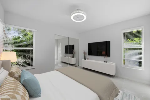 a bedroom with a bed and a flat screen tv