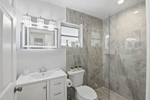 a bathroom with a sink toilet and shower