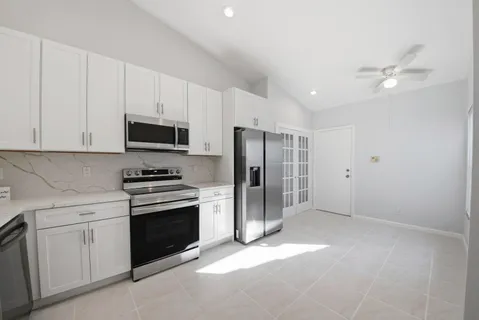 a kitchen with stainless steel appliances a stove a sink and a refrigerator