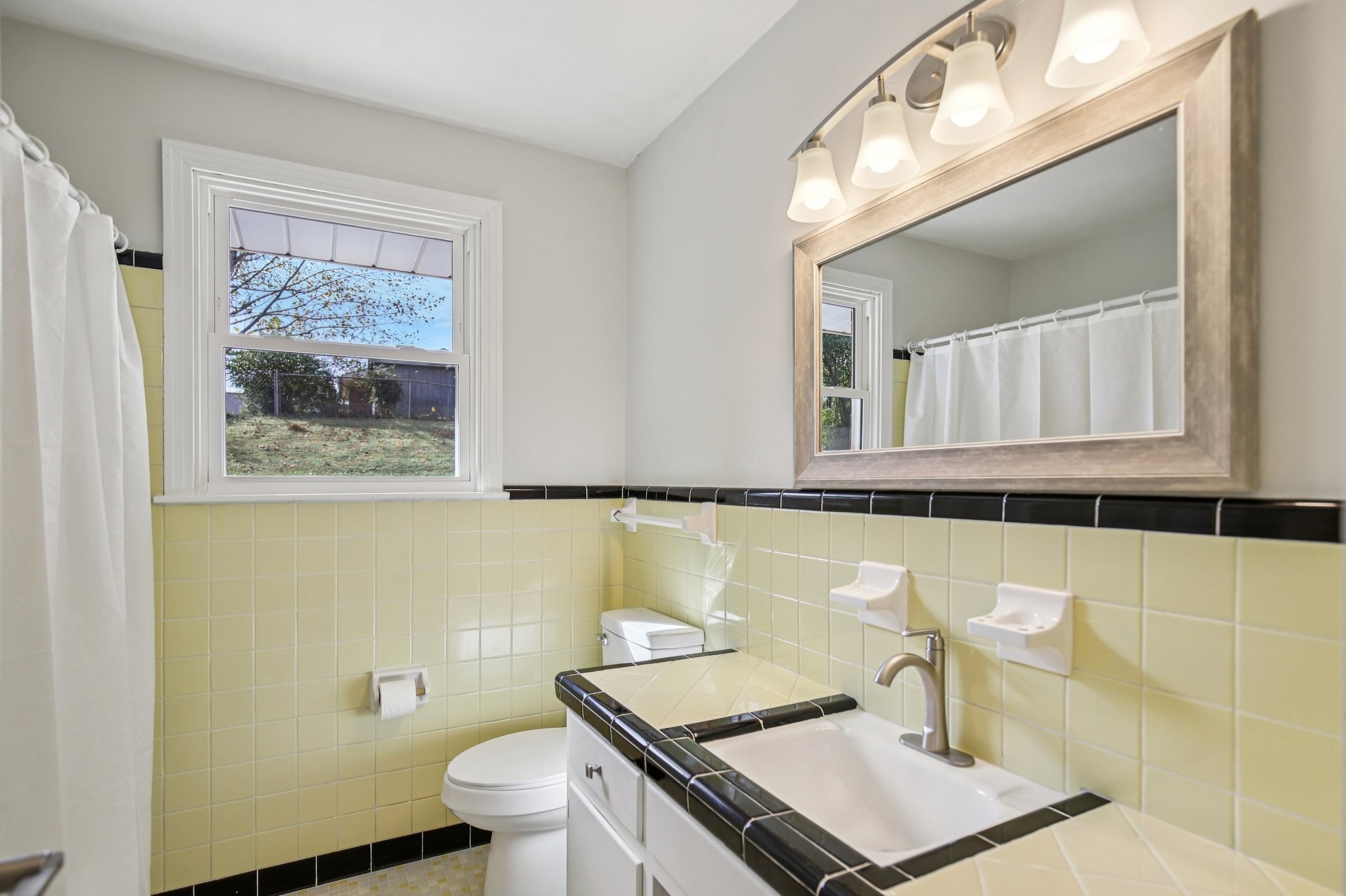 2411 Cloverdale Road Nashville, TN 37214 - Photo 14 of 33 a bathroom with a sink a toilet and a mirror