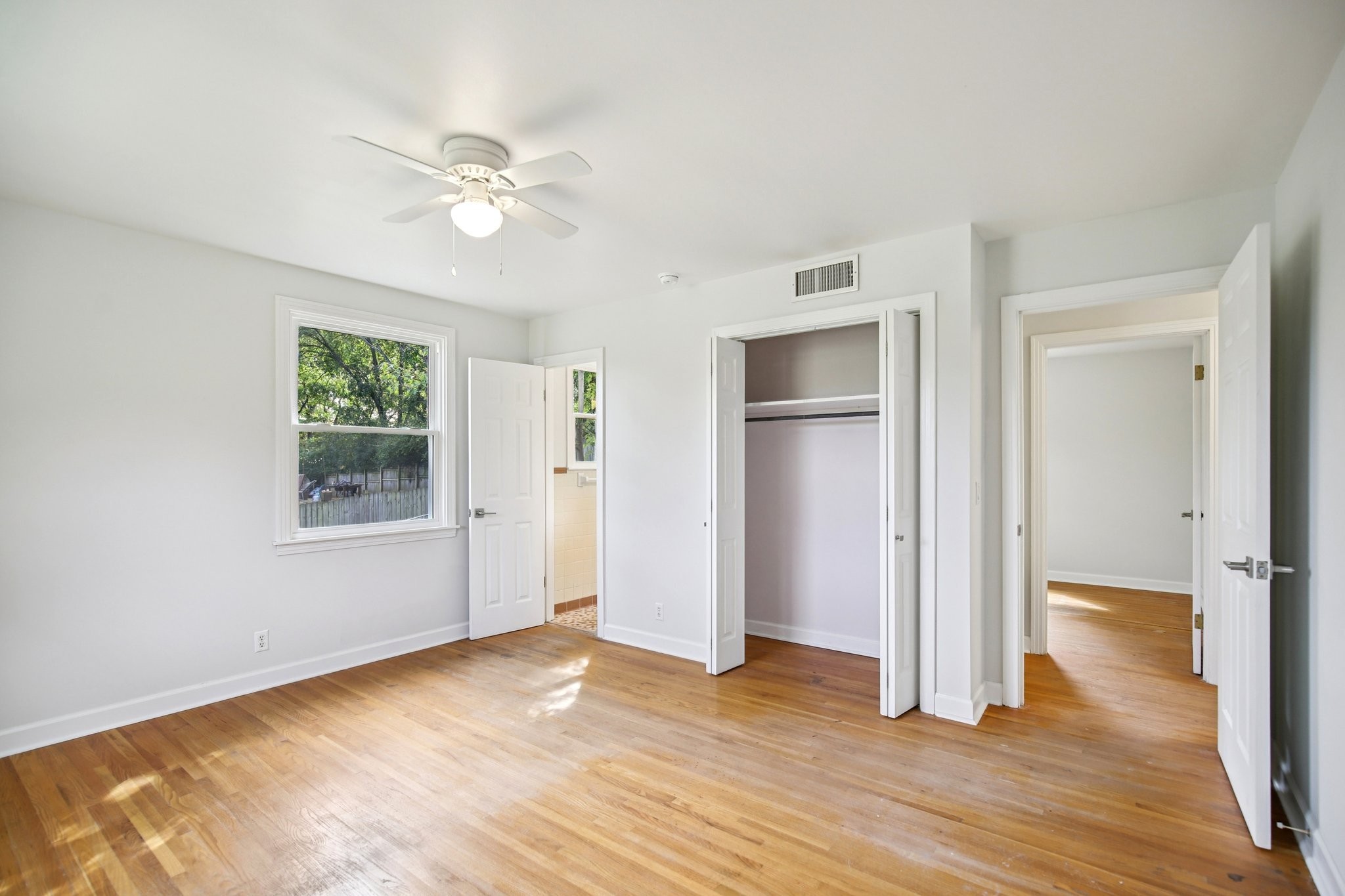 2411 Cloverdale Road Nashville, TN 37214 - Photo 17 of 33 a view of an empty room with wooden floor and a window
