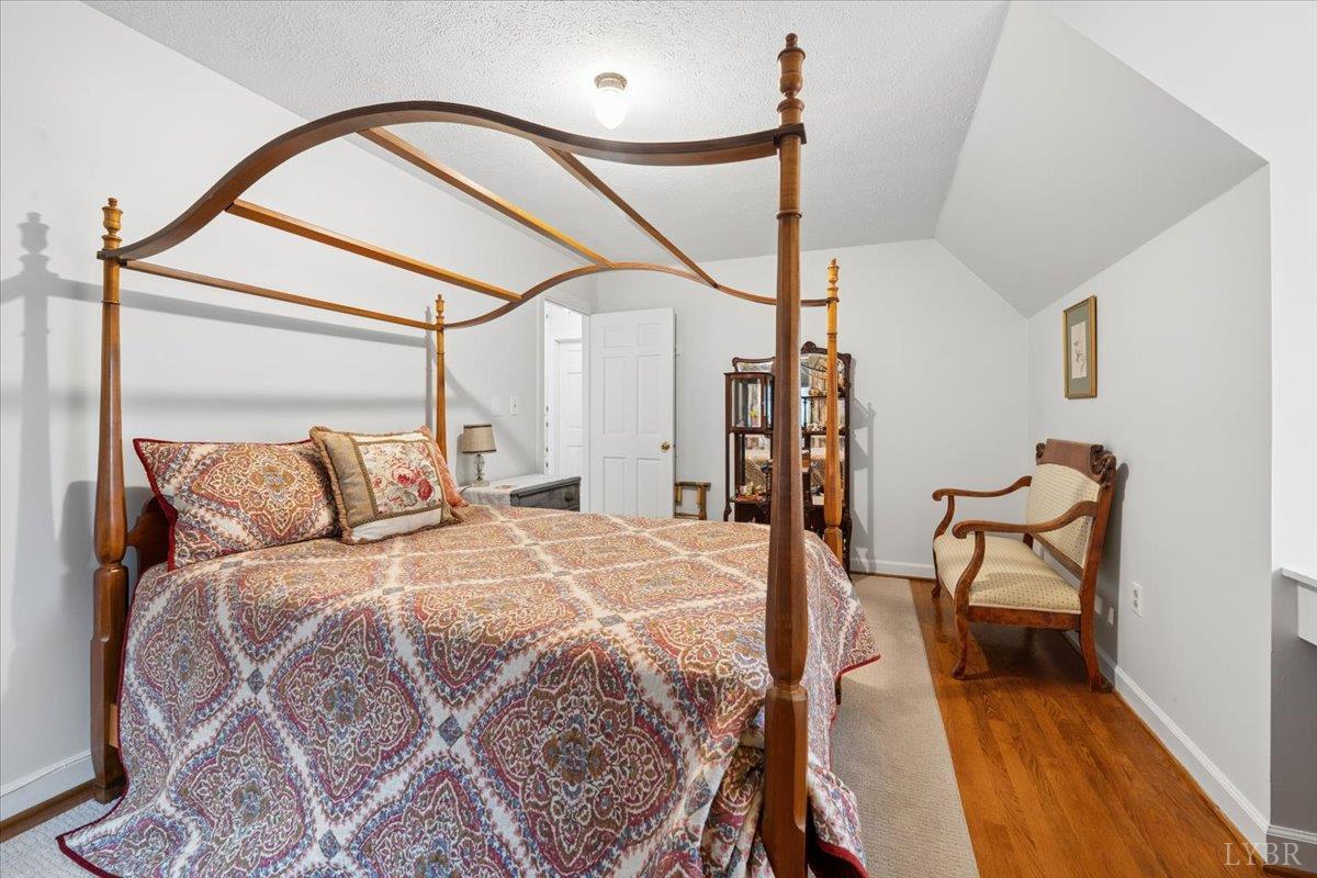 3289 Peaks Road Bedford, VA 24523 - Photo 60 of 71 a bedroom with a bed a table and wooden floor