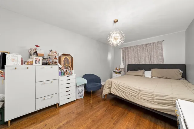 a bedroom with a bed and a chandelier