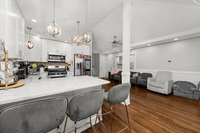 a large kitchen with a table and chairs