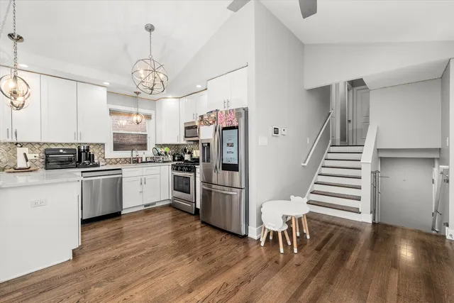 a kitchen with stainless steel appliances a refrigerator a stove a microwave and island