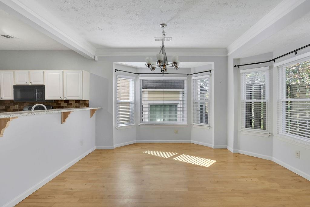 4085 Spring Cove Drive Duluth, GA 30097 - Photo 11 of 45 a view of an empty room with kitchen and window