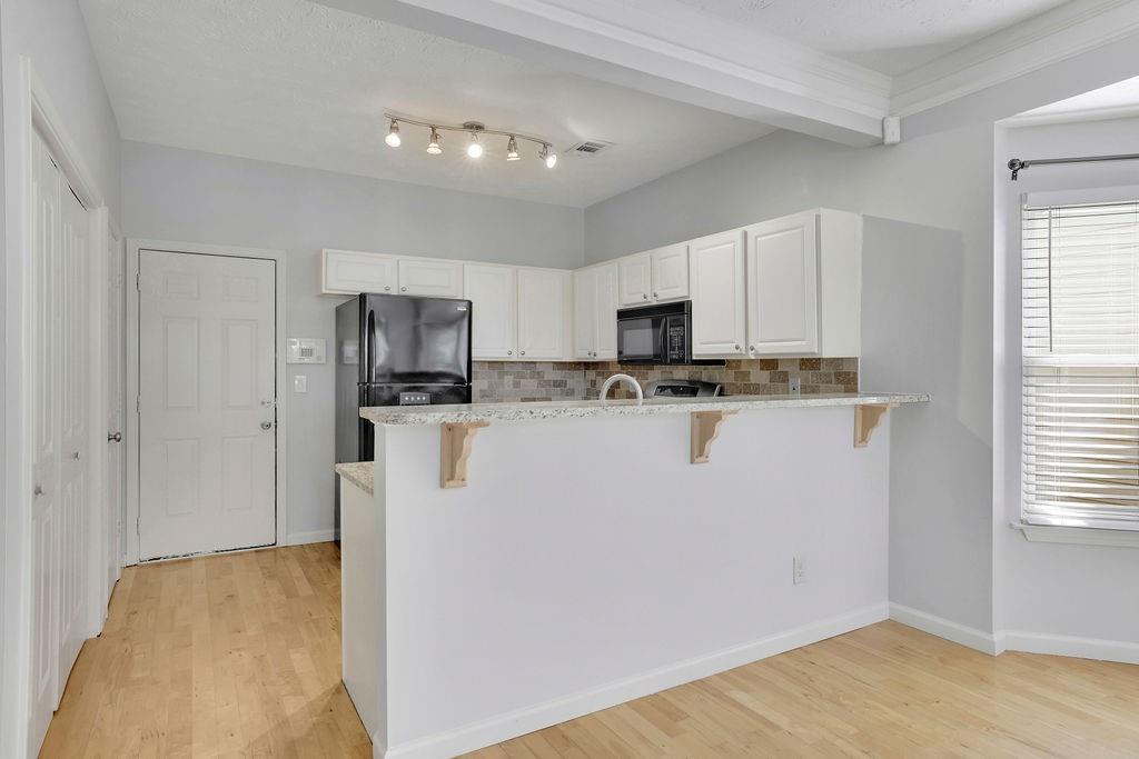 4085 Spring Cove Drive Duluth, GA 30097 - Photo 12 of 45 a kitchen with stainless steel appliances a refrigerator sink and microwave