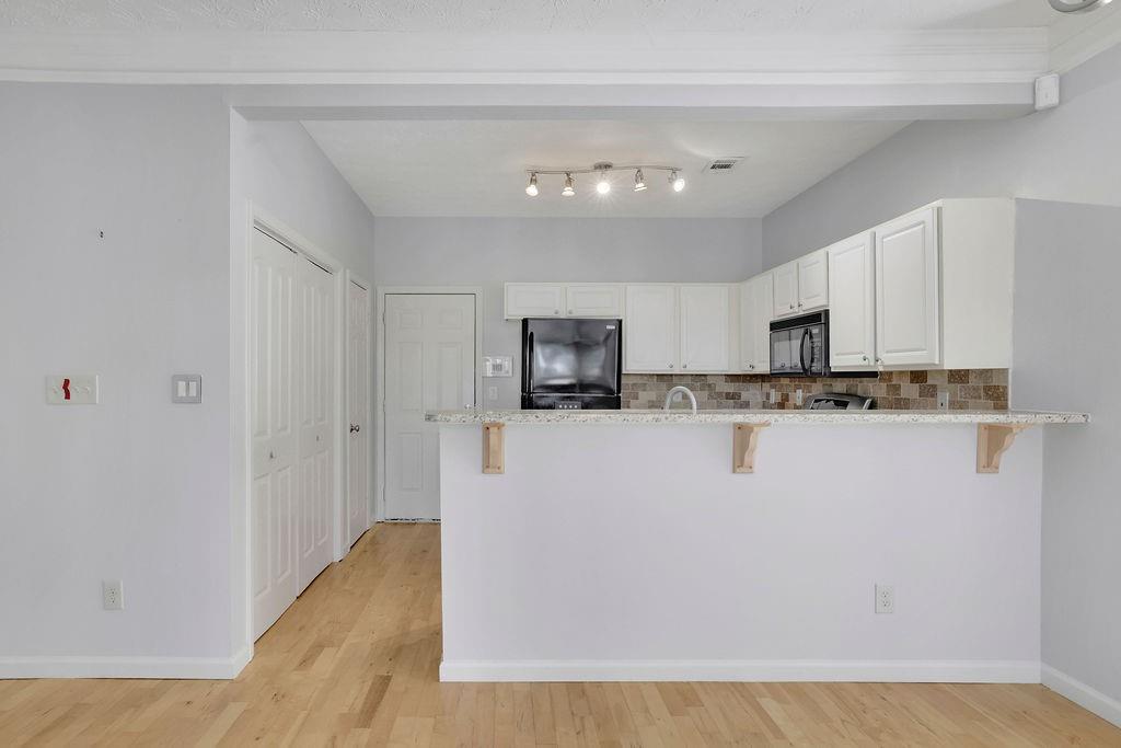 4085 Spring Cove Drive Duluth, GA 30097 - Photo 13 of 45 a view of a kitchen with stainless steel appliances granite countertop a refrigerator a stove a microwave and cabinets