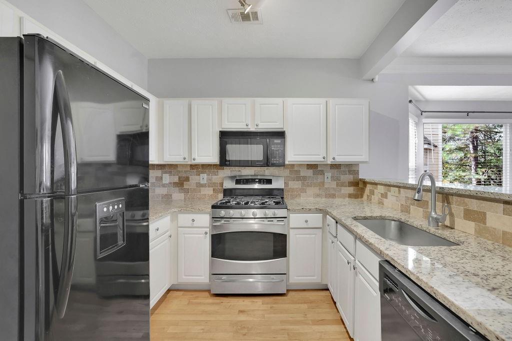 4085 Spring Cove Drive Duluth, GA 30097 - Photo 14 of 45 a kitchen with a stove and a microwave