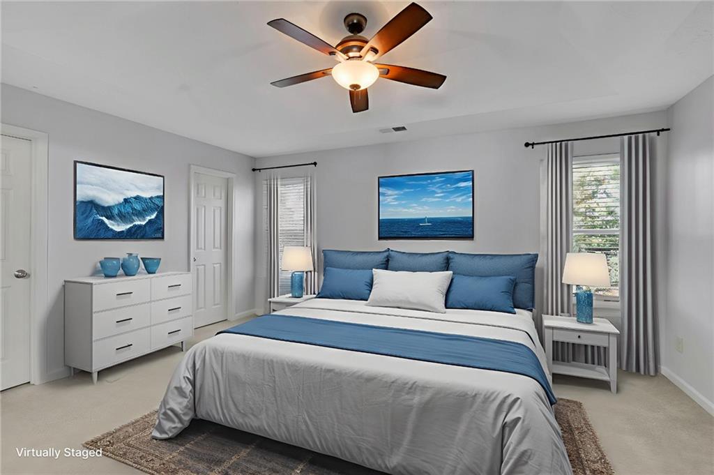 4085 Spring Cove Drive Duluth, GA 30097 - Photo 22 of 45 a bedroom with a bed and a chandelier