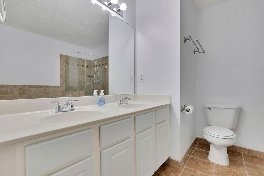 4085 Spring Cove Drive Duluth, GA 30097 - Photo 25 of 45 a bathroom with a toilet sink and mirror